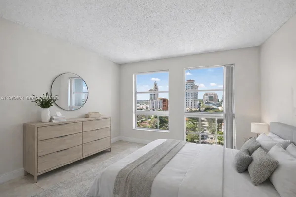 a bedroom with bed and a window