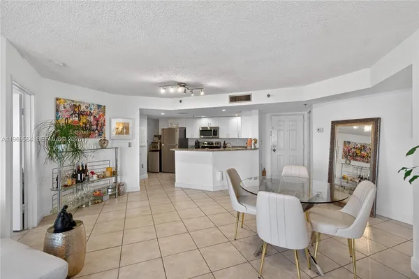 a living room with furniture and kitchen view