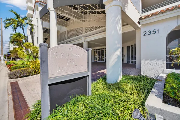 a view of front door and potted plants