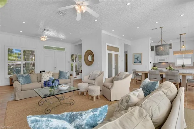 a living room with furniture kitchen and a chandelier