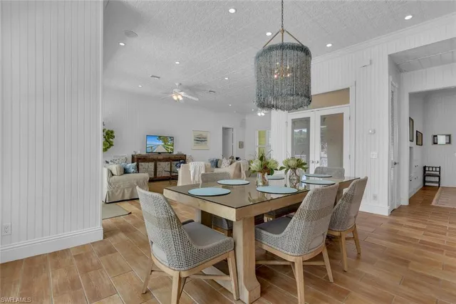 a dining room with furniture a rug and wooden floor