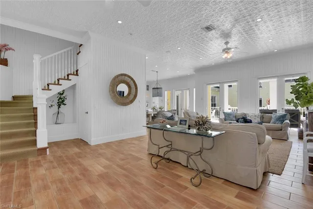 a living room with fireplace furniture and a large window