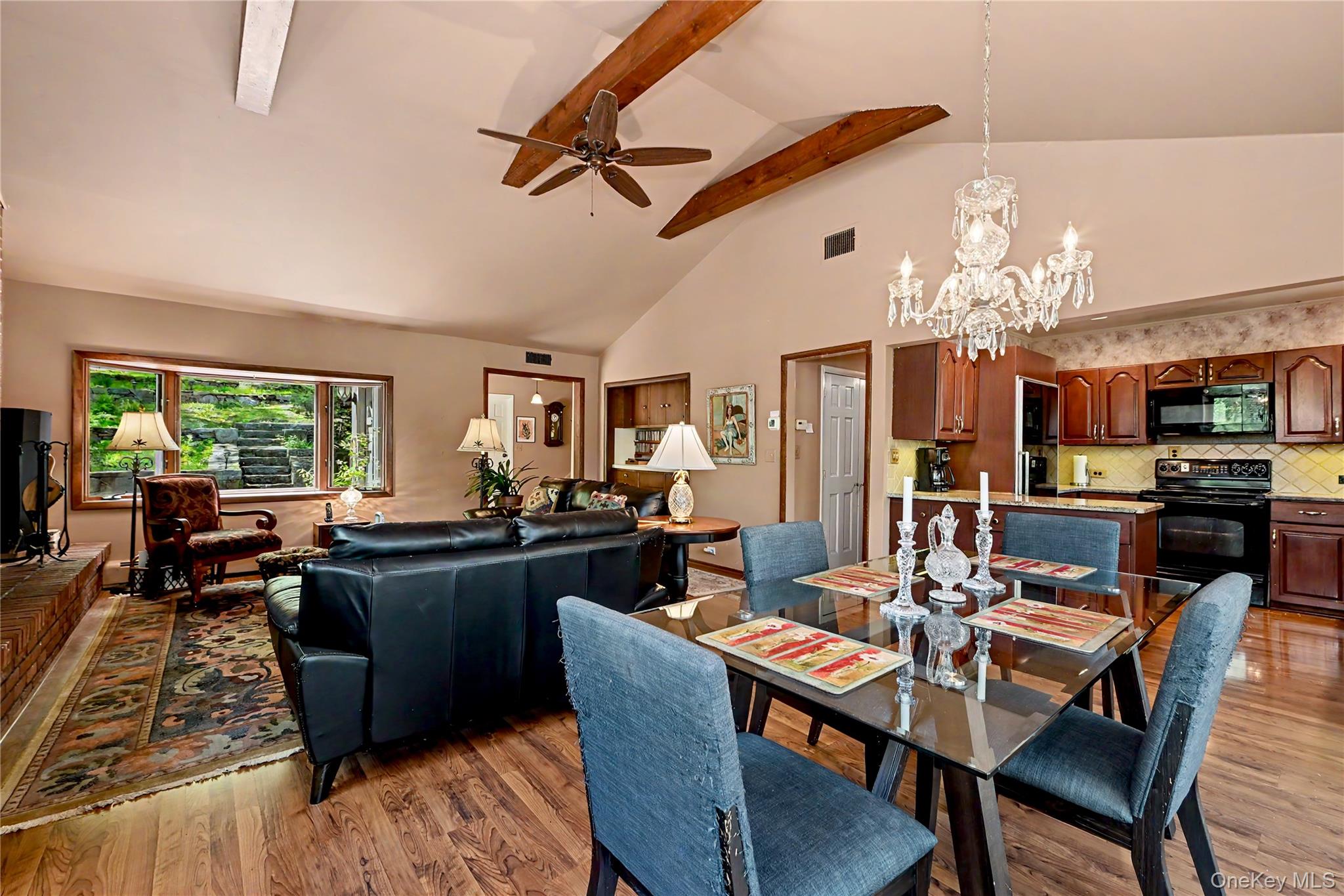 631 Croton Falls Road Carmel, NY 10512 - Photo 11 of 43 a view of a dining room with furniture a kitchen and chandelier