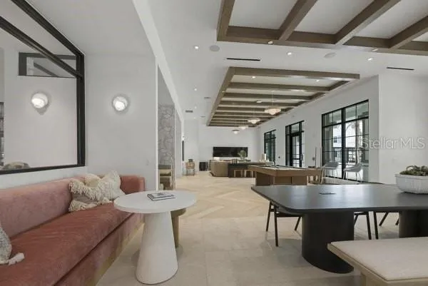 a living room with furniture a table and chairs