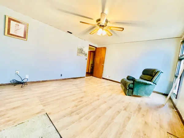 a bedroom with a bed and ceiling fan