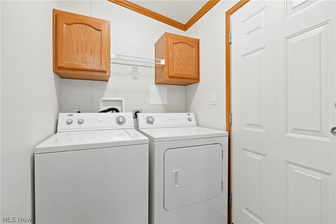 18592 Edwards Road, Unit 122 Doylestown, OH 44230 - Photo 21 of 27 Clothes washing area with cabinets, washer hookup, separate washer and dryer, and crown molding