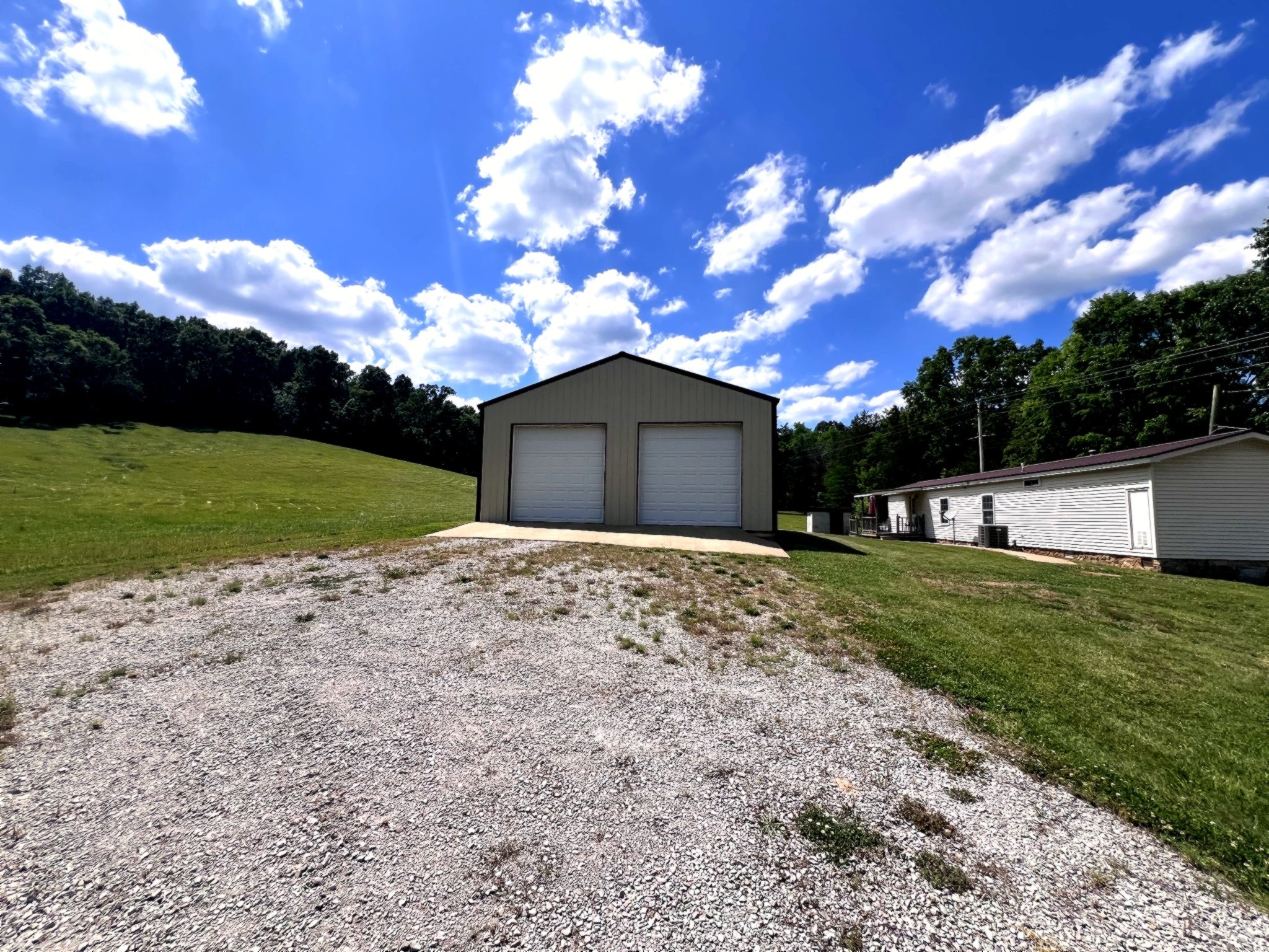 1133 Culps Bend Road Clifton, TN 38425 - Photo 21 of 51 a front view of a house with a garden and trees