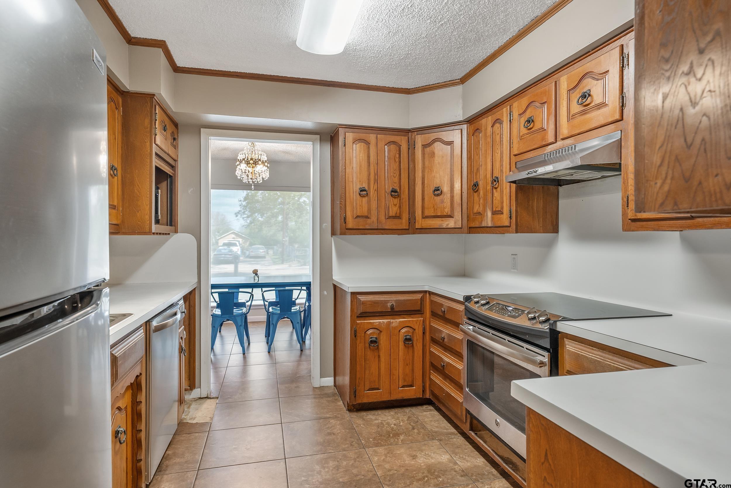 150 Rodney Hawkins, TX 75765 - Photo 16 of 36 a kitchen with stainless steel appliances granite countertop a stove and a refrigerator