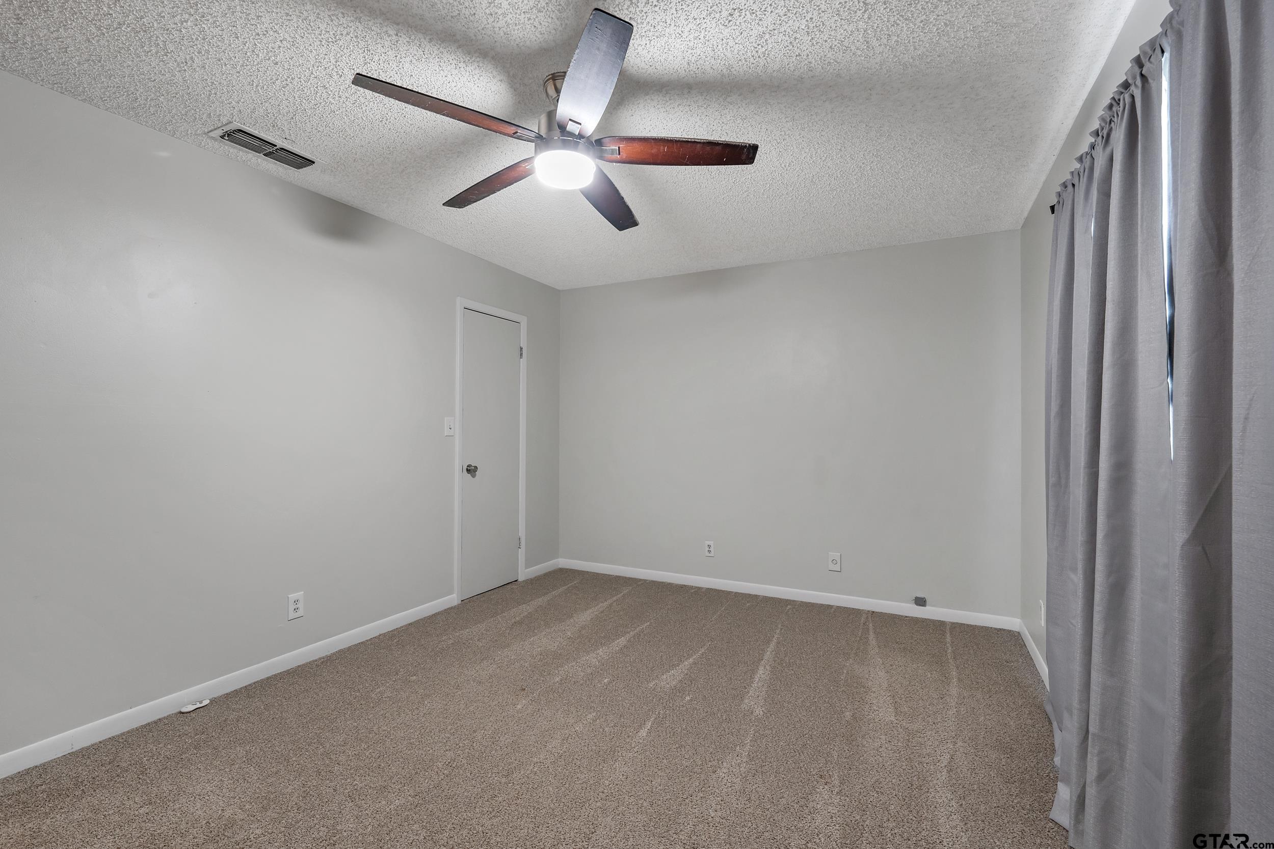 150 Rodney Hawkins, TX 75765 - Photo 18 of 36 an empty room with a window and a fan