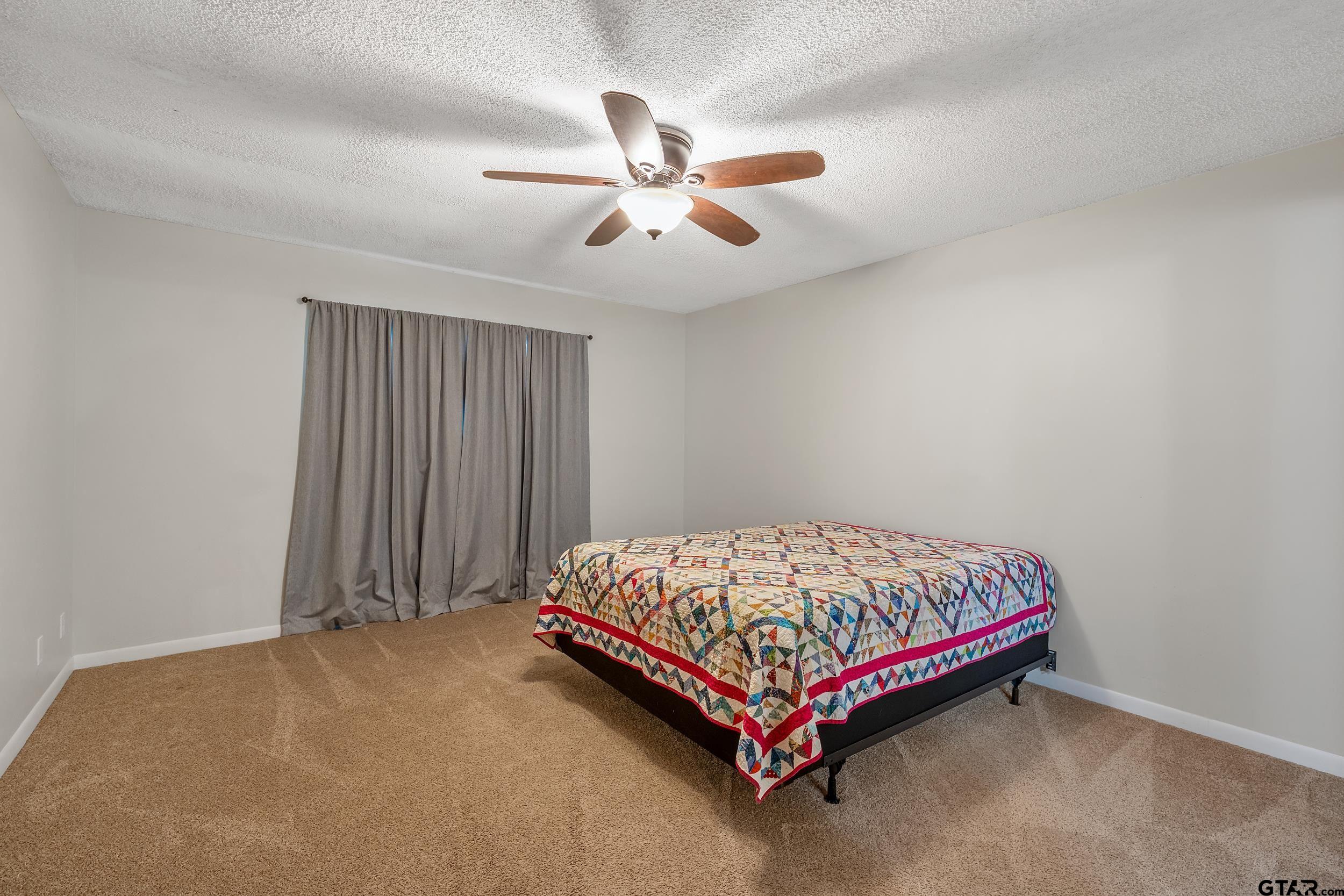 150 Rodney Hawkins, TX 75765 - Photo 22 of 36 a bed sitting in a room next to a window