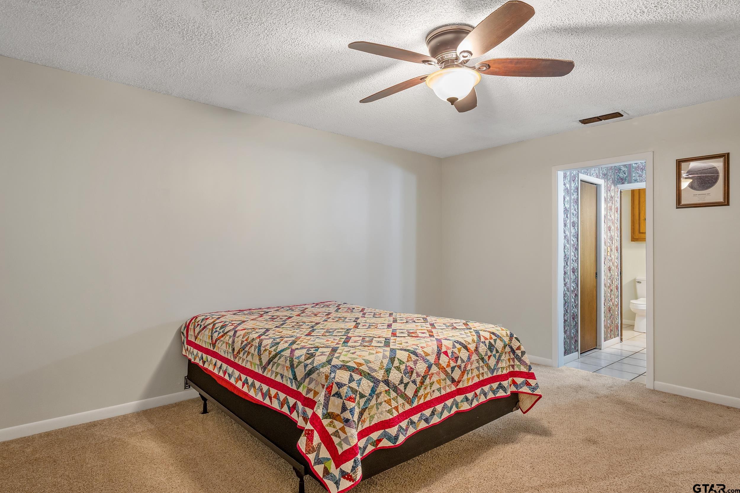 150 Rodney Hawkins, TX 75765 - Photo 23 of 36 a bedroom with a bed and a ceiling fan