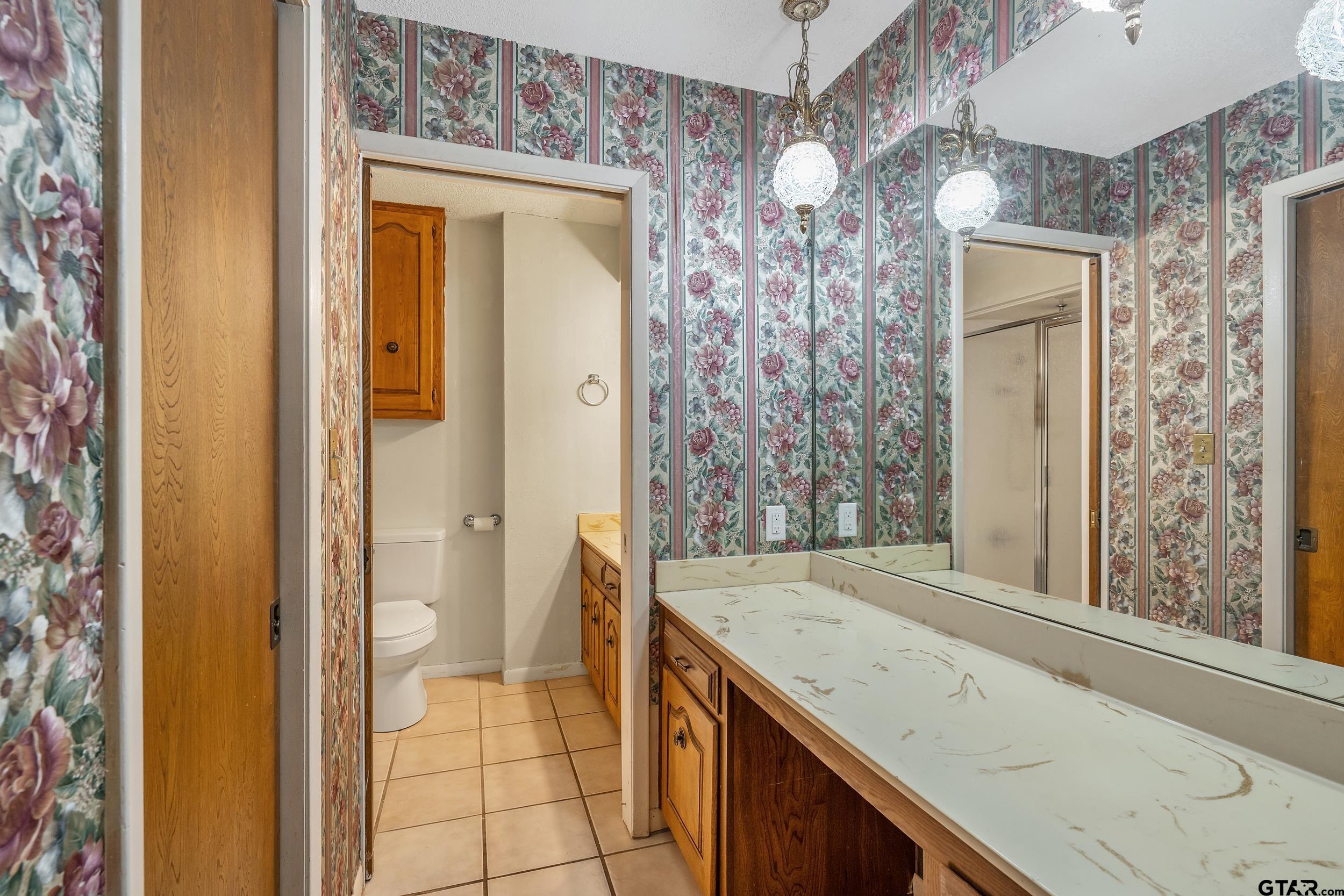 150 Rodney Hawkins, TX 75765 - Photo 24 of 36 a bathroom with a granite countertop sink and a mirror