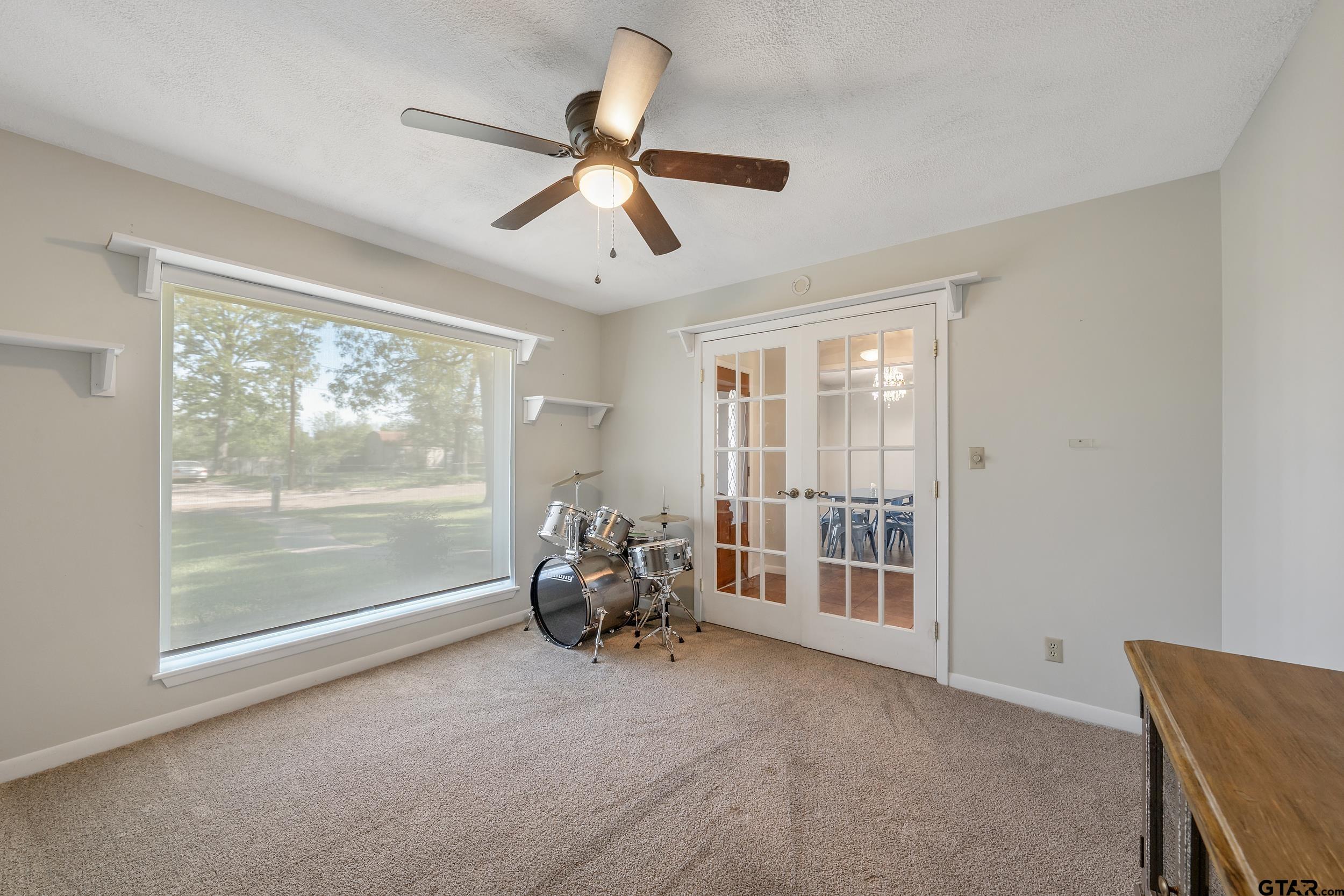 150 Rodney Hawkins, TX 75765 - Photo 10 of 36 a view of a livingroom with a ceiling fan and a large window