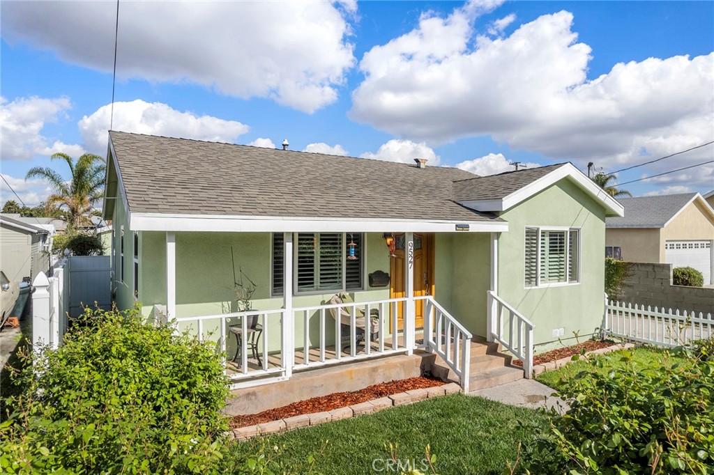 9527 Rendalia Street Bellflower, CA 90706 - Photo 1 of 1 a front view of a house with a yard