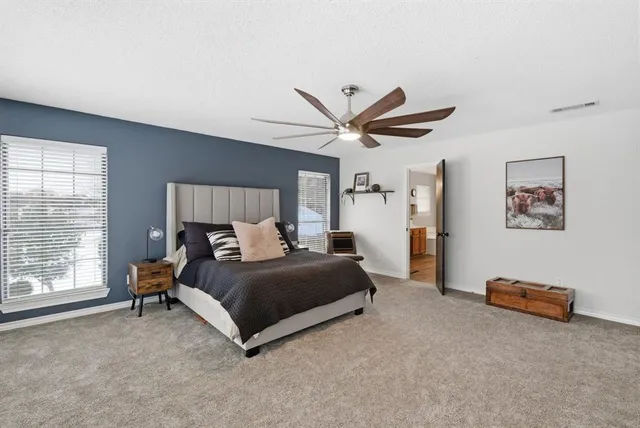 a bed room with a bed and a large window