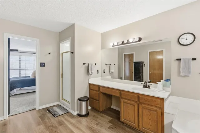 a spacious bathroom with a double vanity sink a mirror and a bathtub