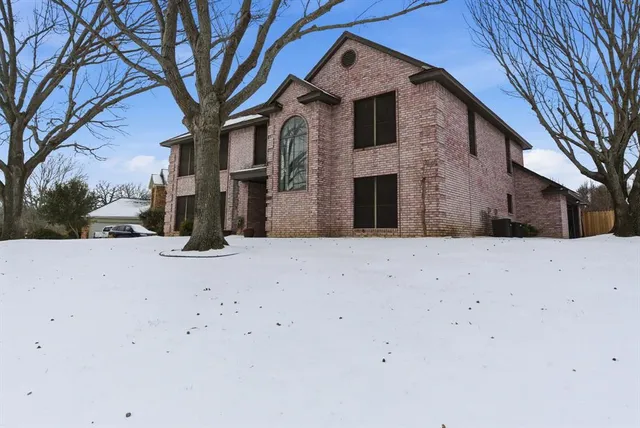 a view of a house with a snow in the yard