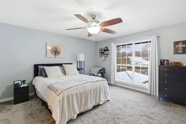 a spacious bedroom with a bed and a window