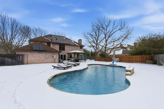 a view of a swimming pool with sitting area