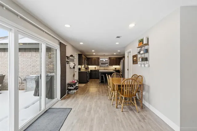 a dining room with furniture and wooden floor