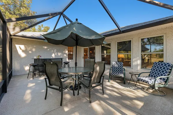 a view of a dinning table and chairs in the patio