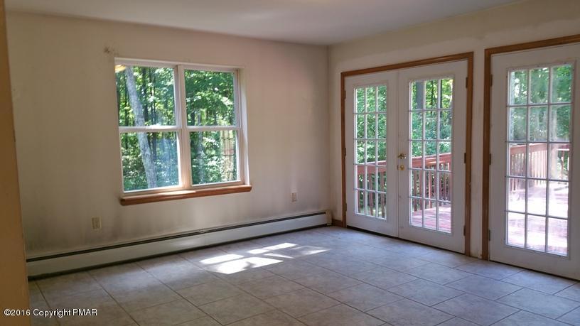 175 Devils Hole Road Cresco, PA 18326 - Photo 5 of 21 a view of an empty room with a large window