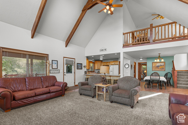 1340 Trapper Loop Garden City, UT 84028 - Photo 9 of 35 Carpeted living room featuring ceiling fan, high vaulted ceiling, stairs, and beamed ceiling