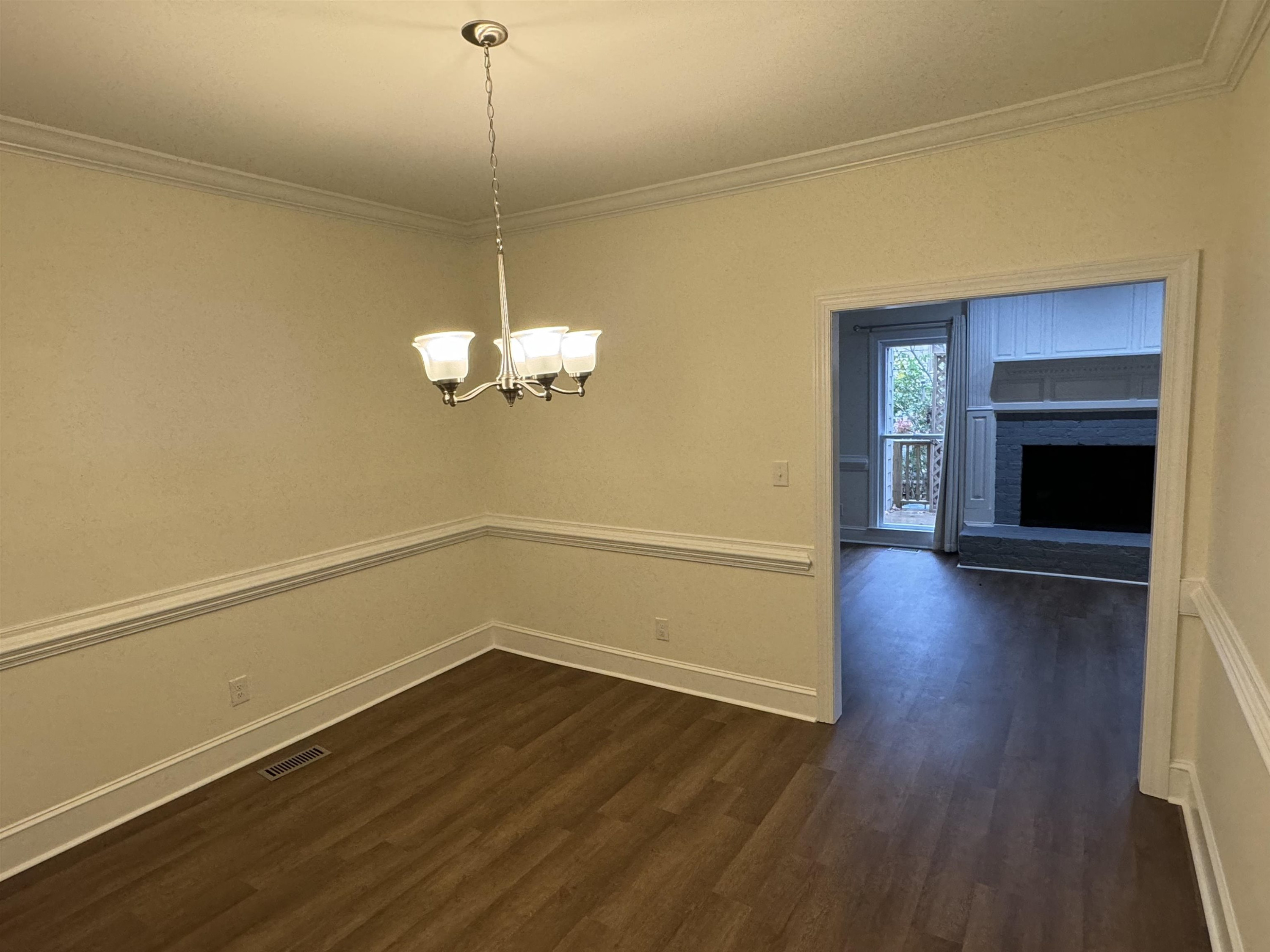 1419 Fowlkes Place Raleigh, NC 27612 - Photo 3 of 9 a view of a room with wooden floor and fireplace