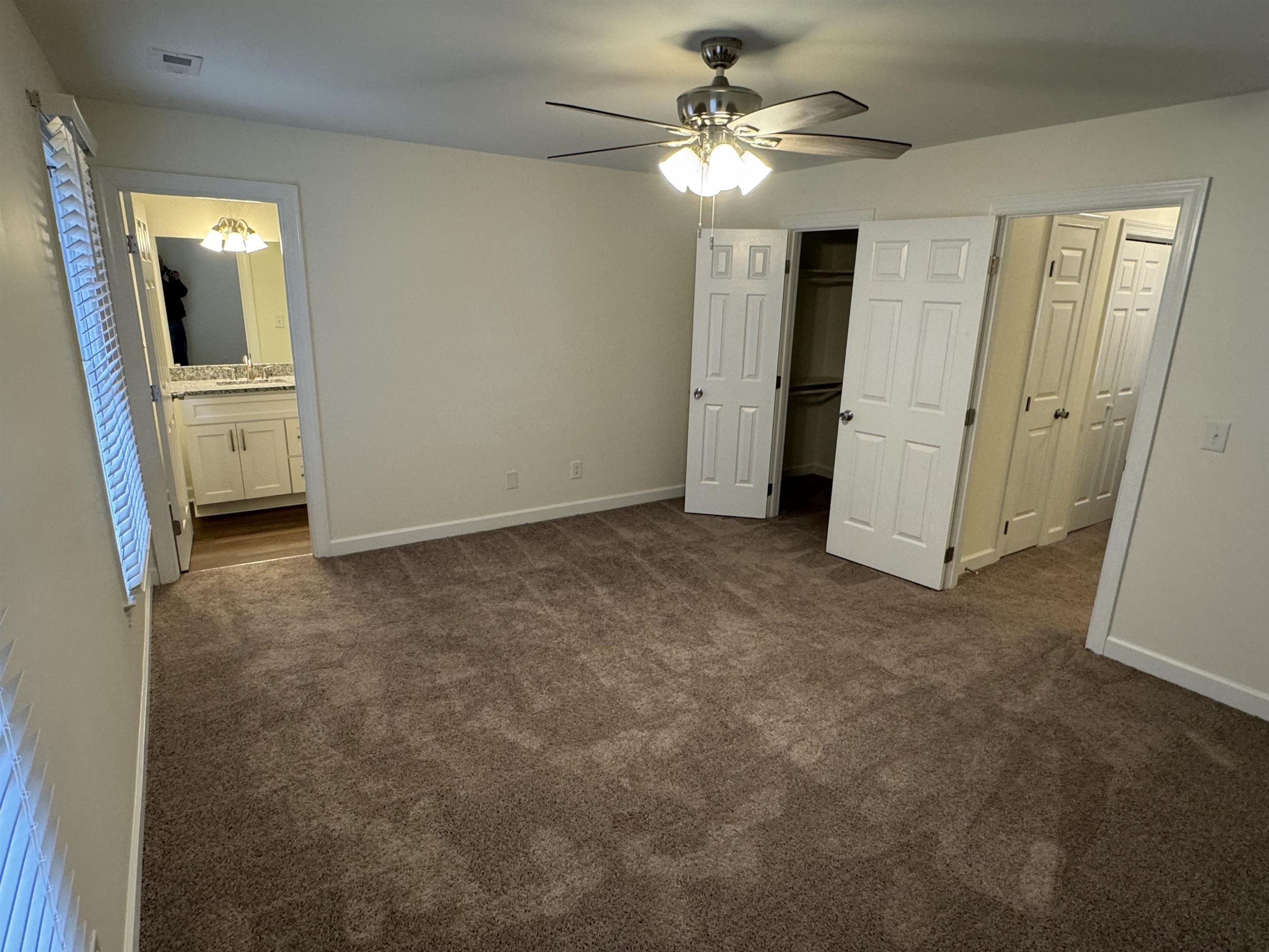 1419 Fowlkes Place Raleigh, NC 27612 - Photo 5 of 9 an empty room with windows and fan