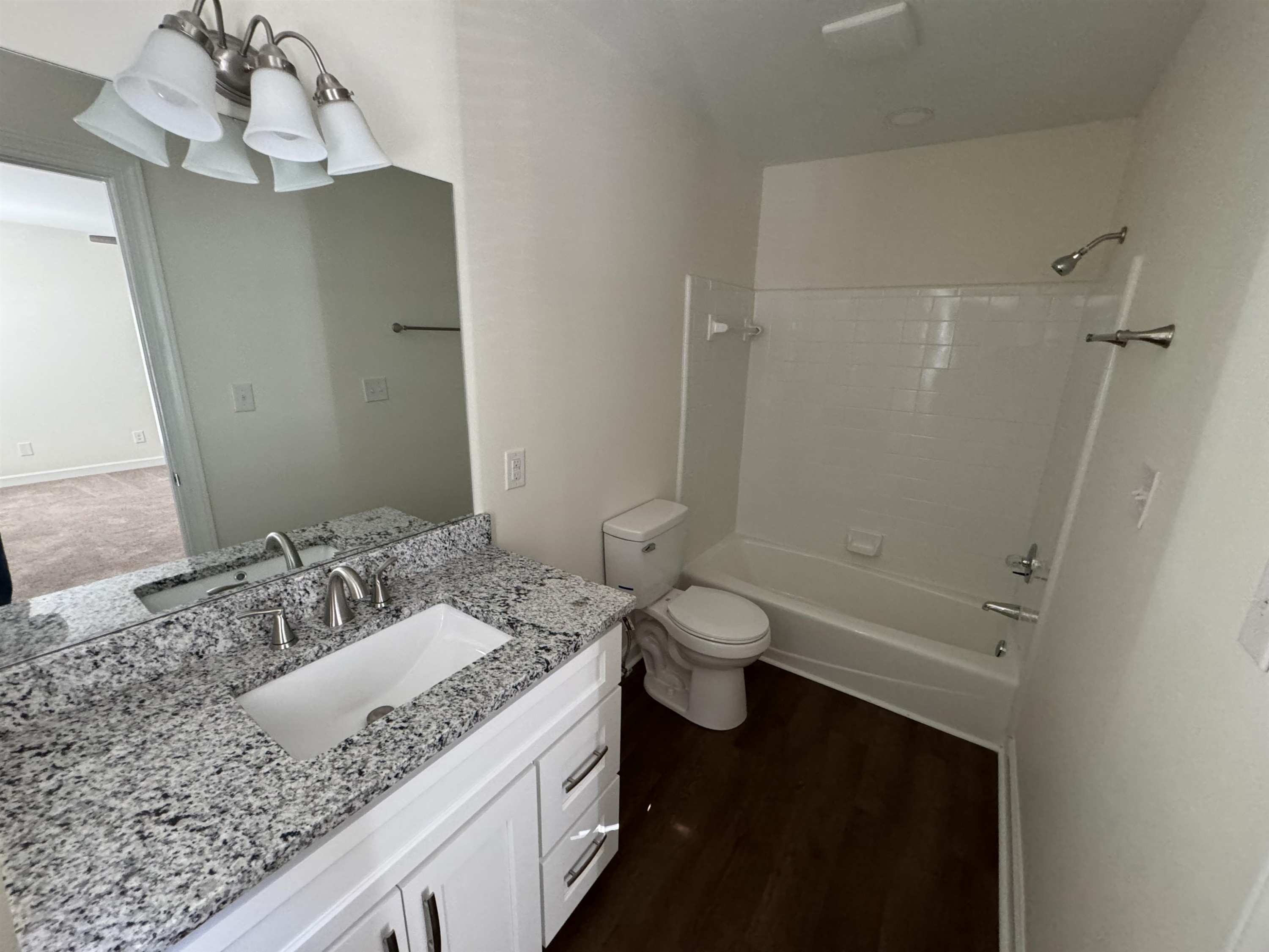 1419 Fowlkes Place Raleigh, NC 27612 - Photo 6 of 9 a bathroom with a granite countertop sink a toilet and shower
