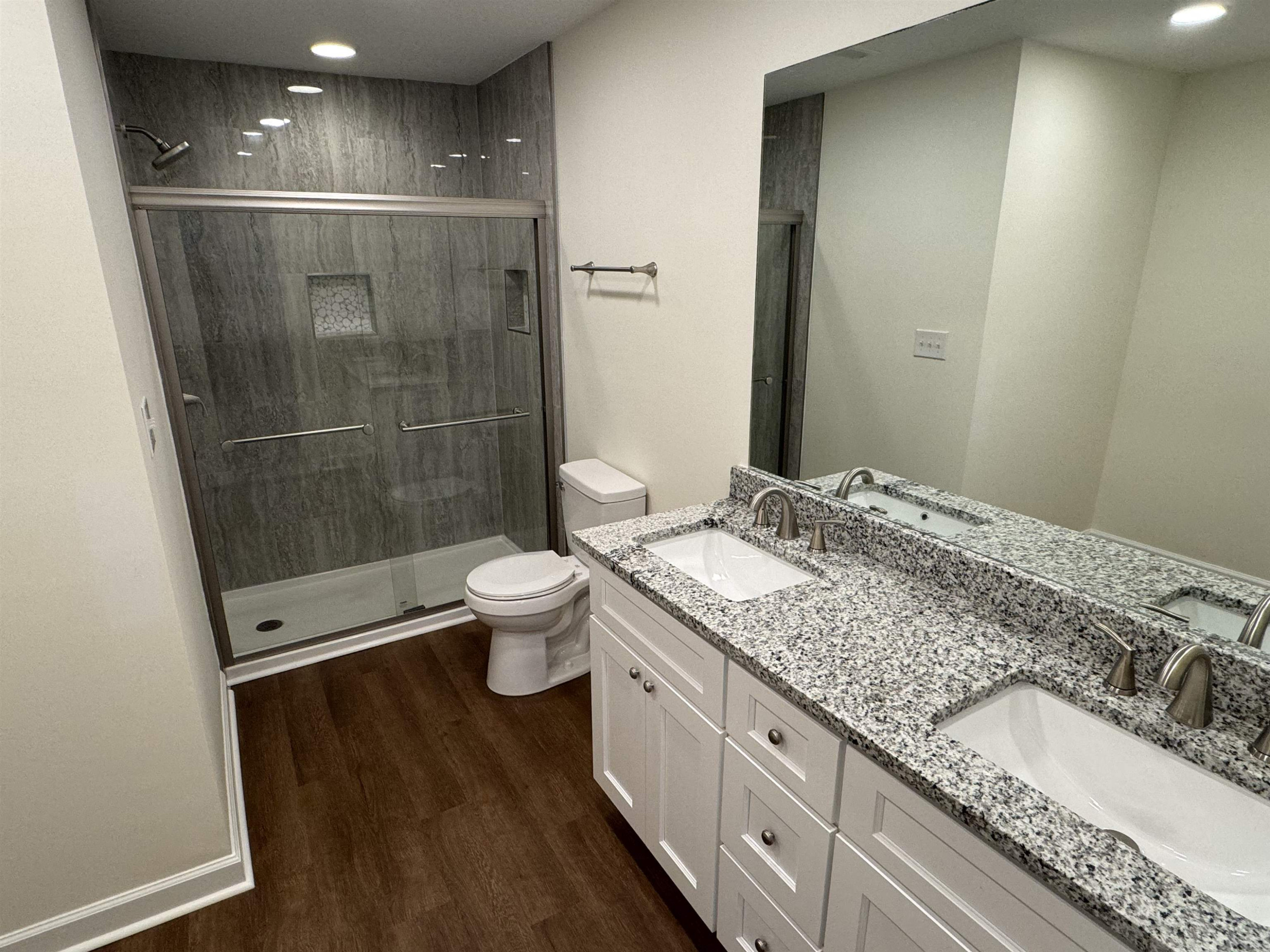 1419 Fowlkes Place Raleigh, NC 27612 - Photo 8 of 9 a bathroom with a granite countertop sink a toilet and shower