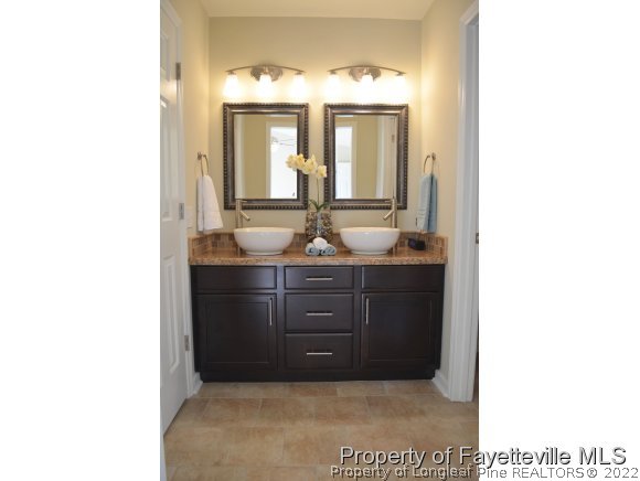 966 Rim Road Fayetteville, NC 28314 - Photo 12 of 18 a bathroom with a sink and a mirror