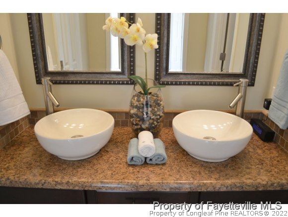 966 Rim Road Fayetteville, NC 28314 - Photo 13 of 18 a bathroom with a granite countertop sink and a mirror