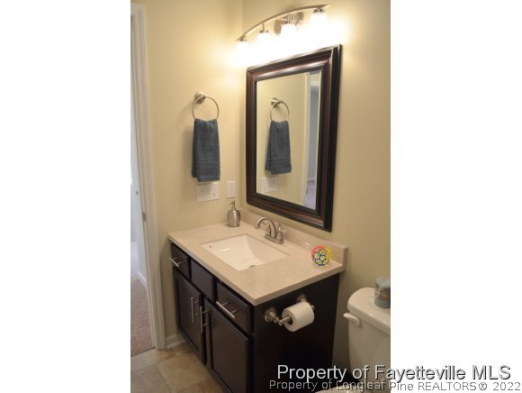 966 Rim Road Fayetteville, NC 28314 - Photo 16 of 18 a bathroom with a sink and a mirror