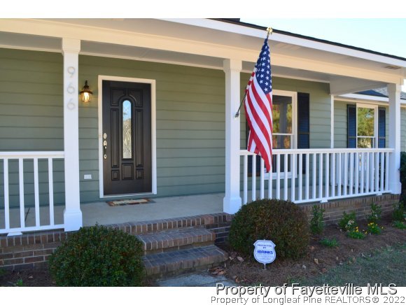 966 Rim Road Fayetteville, NC 28314 - Photo 2 of 18 a view of a house with a yard and deck