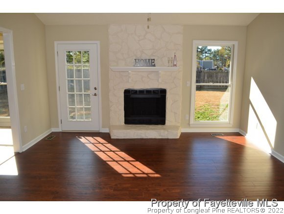 966 Rim Road Fayetteville, NC 28314 - Photo 4 of 18 a view of an empty room with wooden floor and a window
