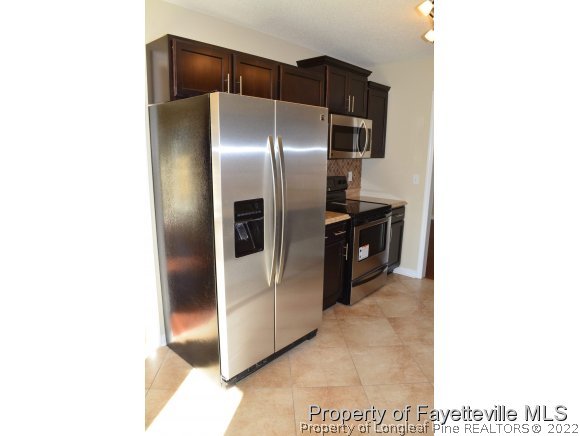 966 Rim Road Fayetteville, NC 28314 - Photo 6 of 18 a kitchen with cabinets and stainless steel appliances
