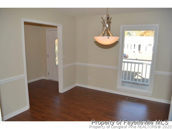 966 Rim Road Fayetteville, NC 28314 - Photo 8 of 18 a view of empty room with wooden floor and fan