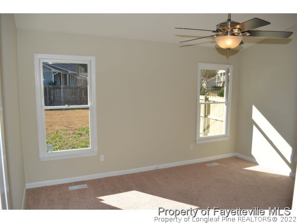 966 Rim Road Fayetteville, NC 28314 - Photo 10 of 18 a view of an empty room with wooden floor and a window
