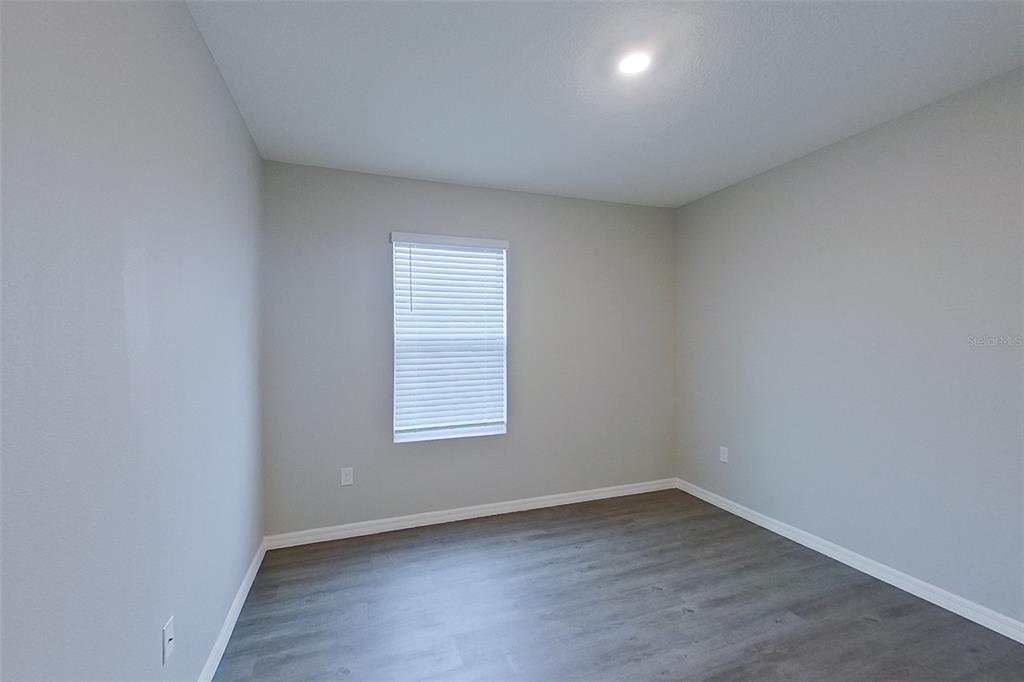 32037 Katelin Circle Leesburg, FL 34748 - Photo 13 of 20 an empty room with wooden floor and windows