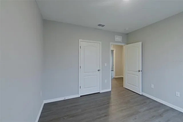 a view of an empty room and wooden floor