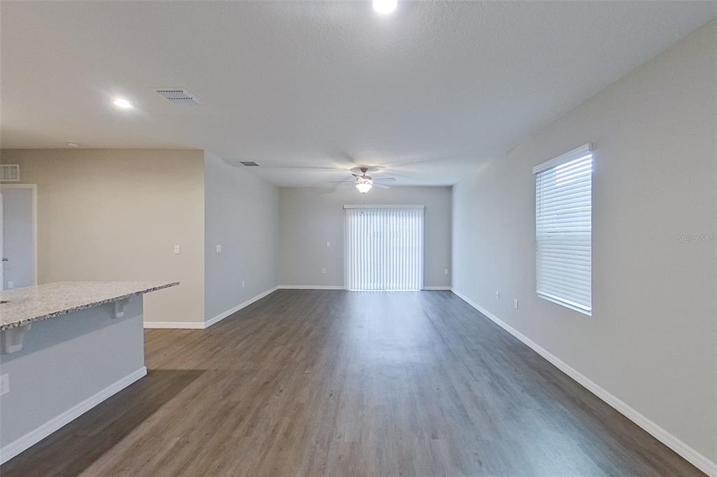 32037 Katelin Circle Leesburg, FL 34748 - Photo 2 of 20 an empty room with wooden floor and windows