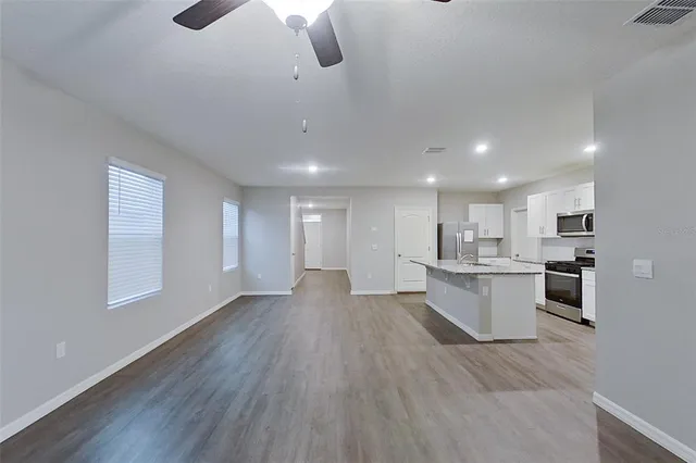 a view of kitchen with sink and wooden floor