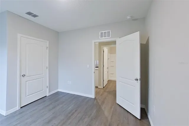 a view of a room with wooden floor