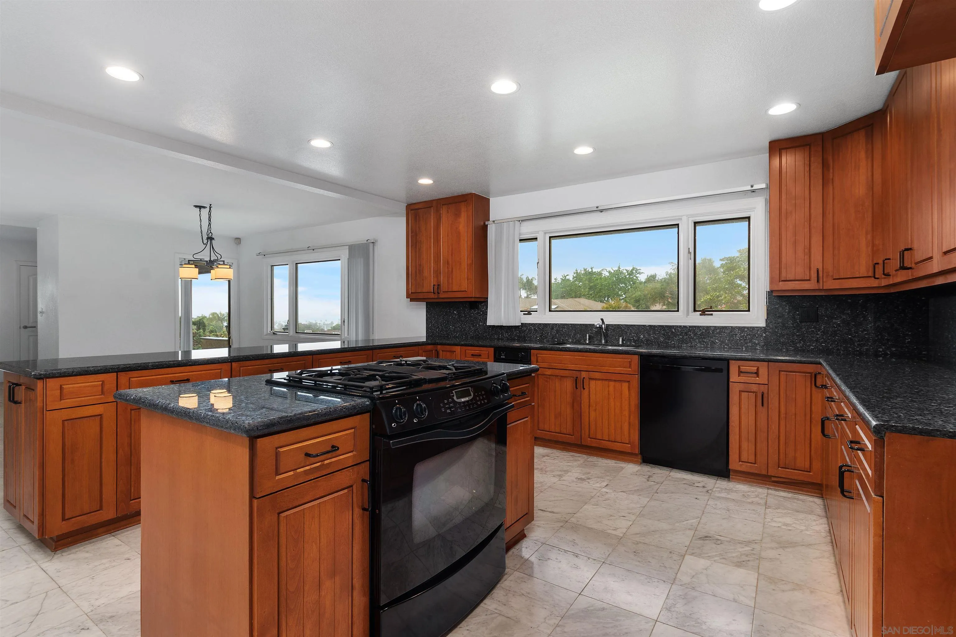 2435 Paseo Dorado La Jolla, CA 92037 - Photo 16 of 40 a kitchen with stainless steel appliances granite countertop a stove a sink and a microwave