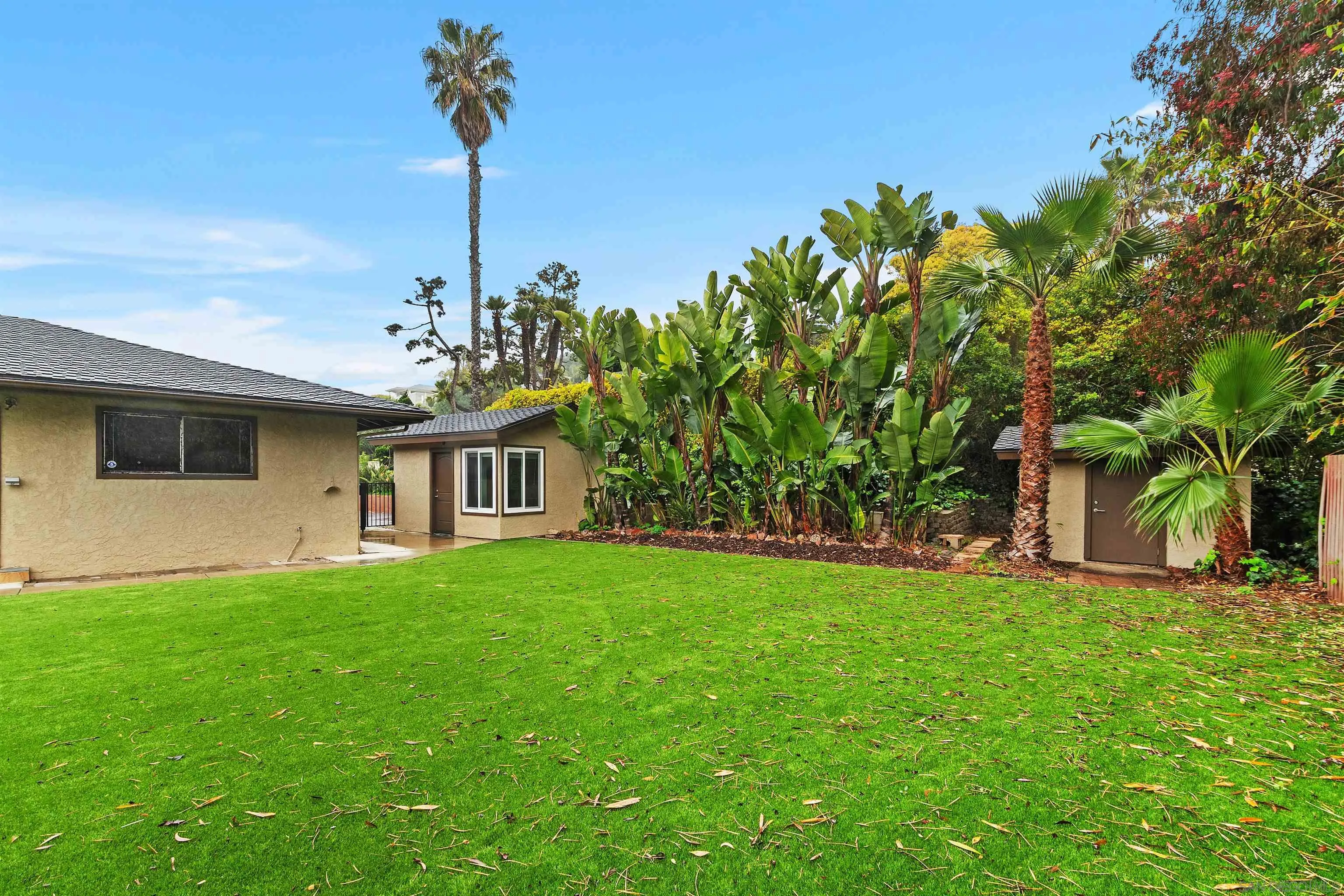 2435 Paseo Dorado La Jolla, CA 92037 - Photo 19 of 40 a front view of a house with a garden and yard