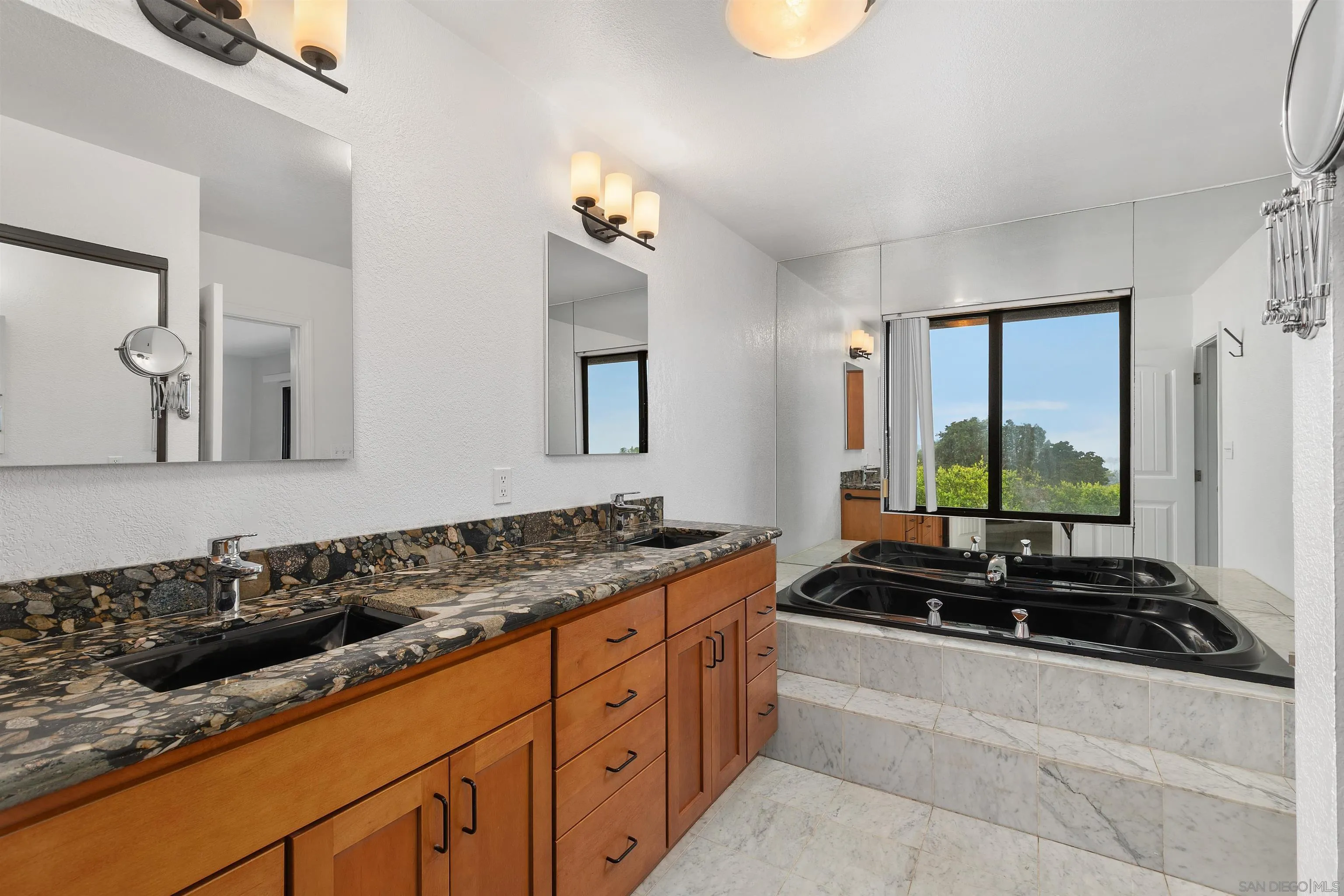2435 Paseo Dorado La Jolla, CA 92037 - Photo 22 of 40 a bathroom with a granite countertop sink and a mirror