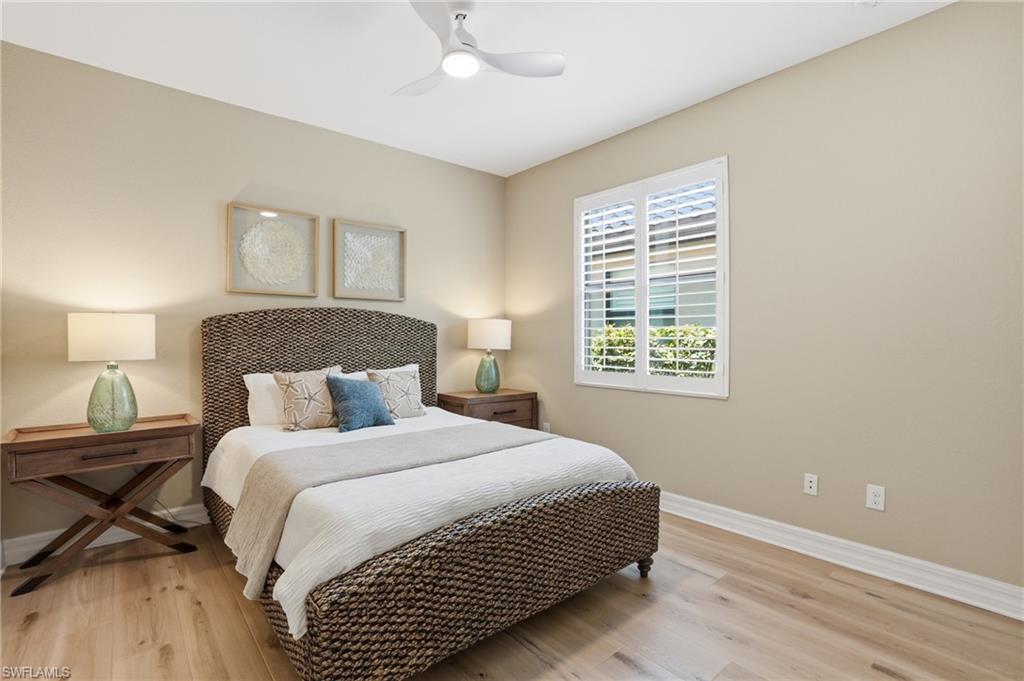 3058 Aviamar Circle Naples, FL 34114 - Photo 19 of 50 Bedroom featuring light-tone wood-finish flooring, neutral wall paint, and a white ceiling fan