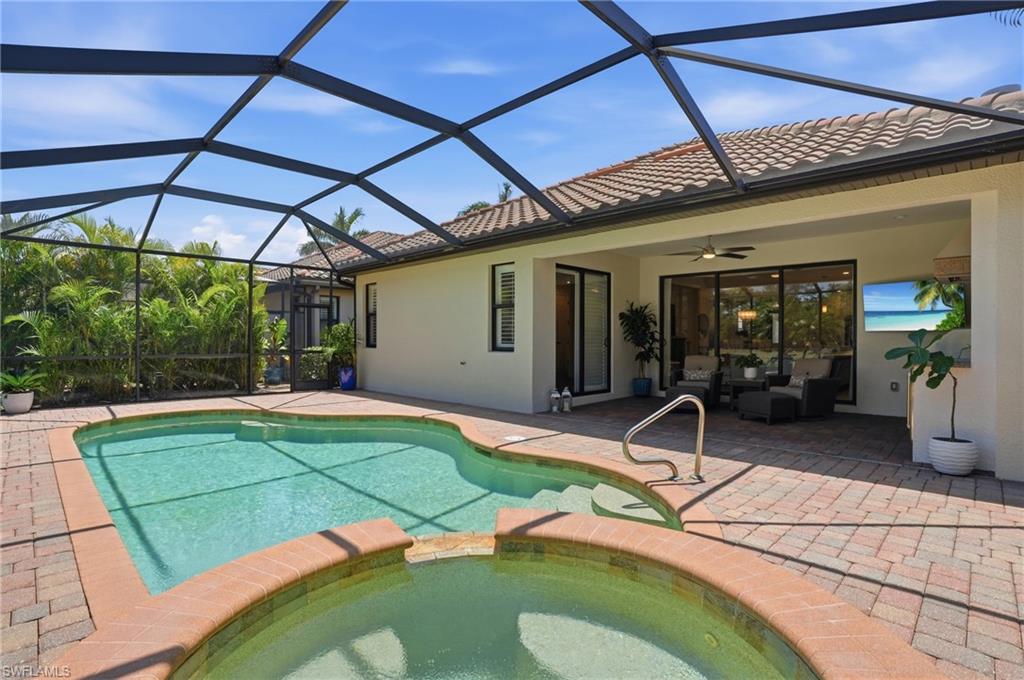 3058 Aviamar Circle Naples, FL 34114 - Photo 21 of 50 Screened lanai featuring a swimming pool and attached spa with brick coping
