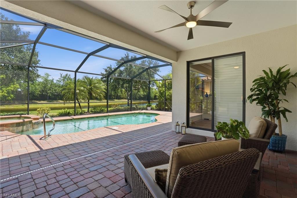 3058 Aviamar Circle Naples, FL 34114 - Photo 25 of 50 Screened lanai featuring a swimming pool, integrated spa, and brick paver patio